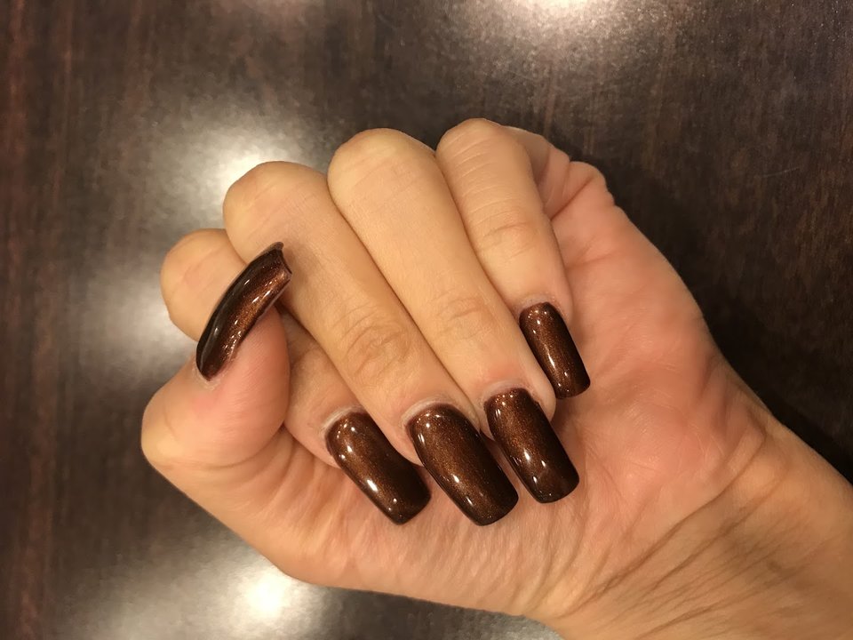 Manicured nails with glossy polish on display.
